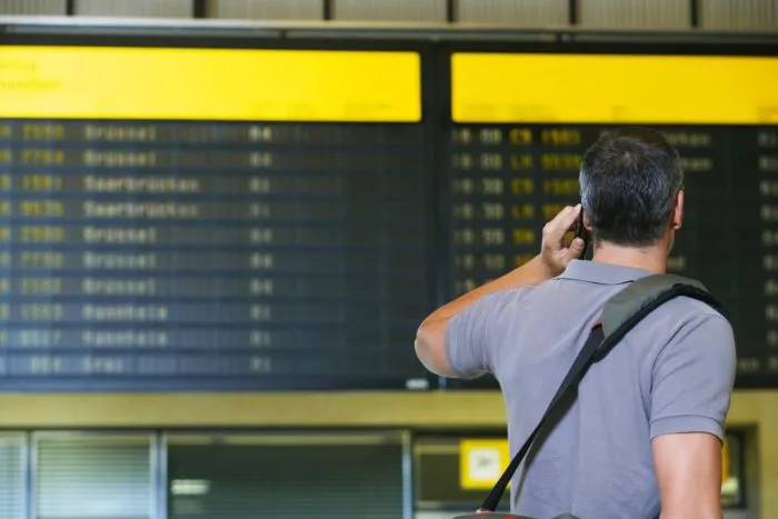 Man looking for flight information amid COVID-19 flight cancelations