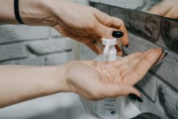 someone applying hand sanitizer regarding Health Canada lifting restrictions on using technical-grade ethanol amid COVID-19 pandemic 