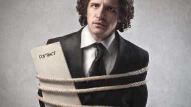 Man bound with rope and a contract regarding information on whether a class action lawsuit is a legally binding contract or not