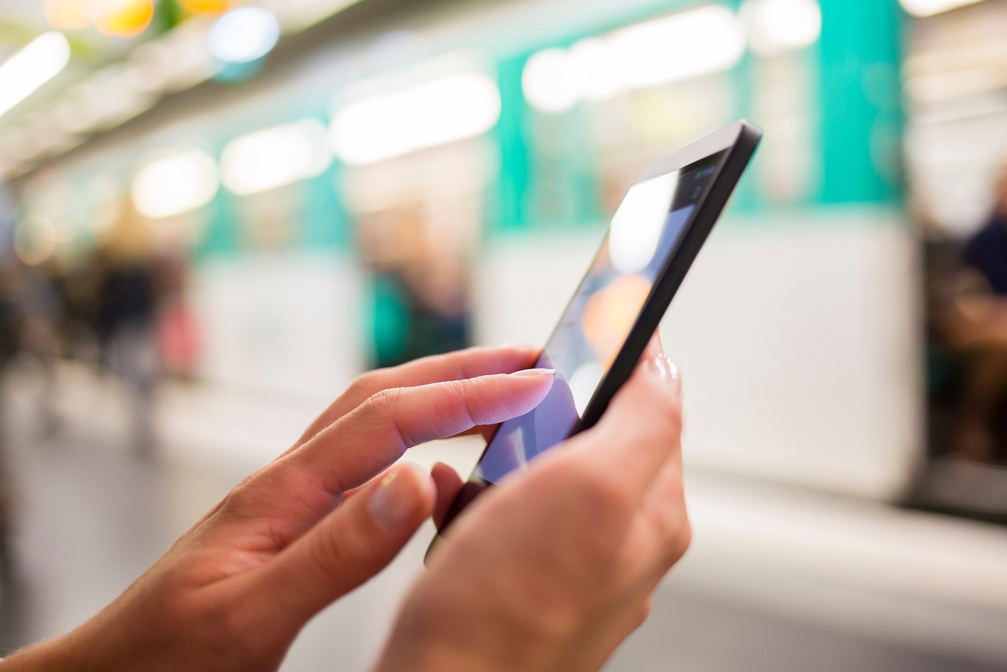 Hand holding a smartphone at station regarding the privacy concerns raised over Canada's COVID-19 response