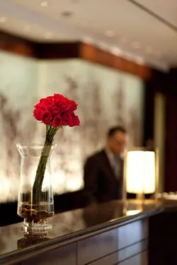 Blurred hotel receptionist regarding the lawsuit filed against a Calgary hotel claiming the owners knew the staff member who raped her was a risk