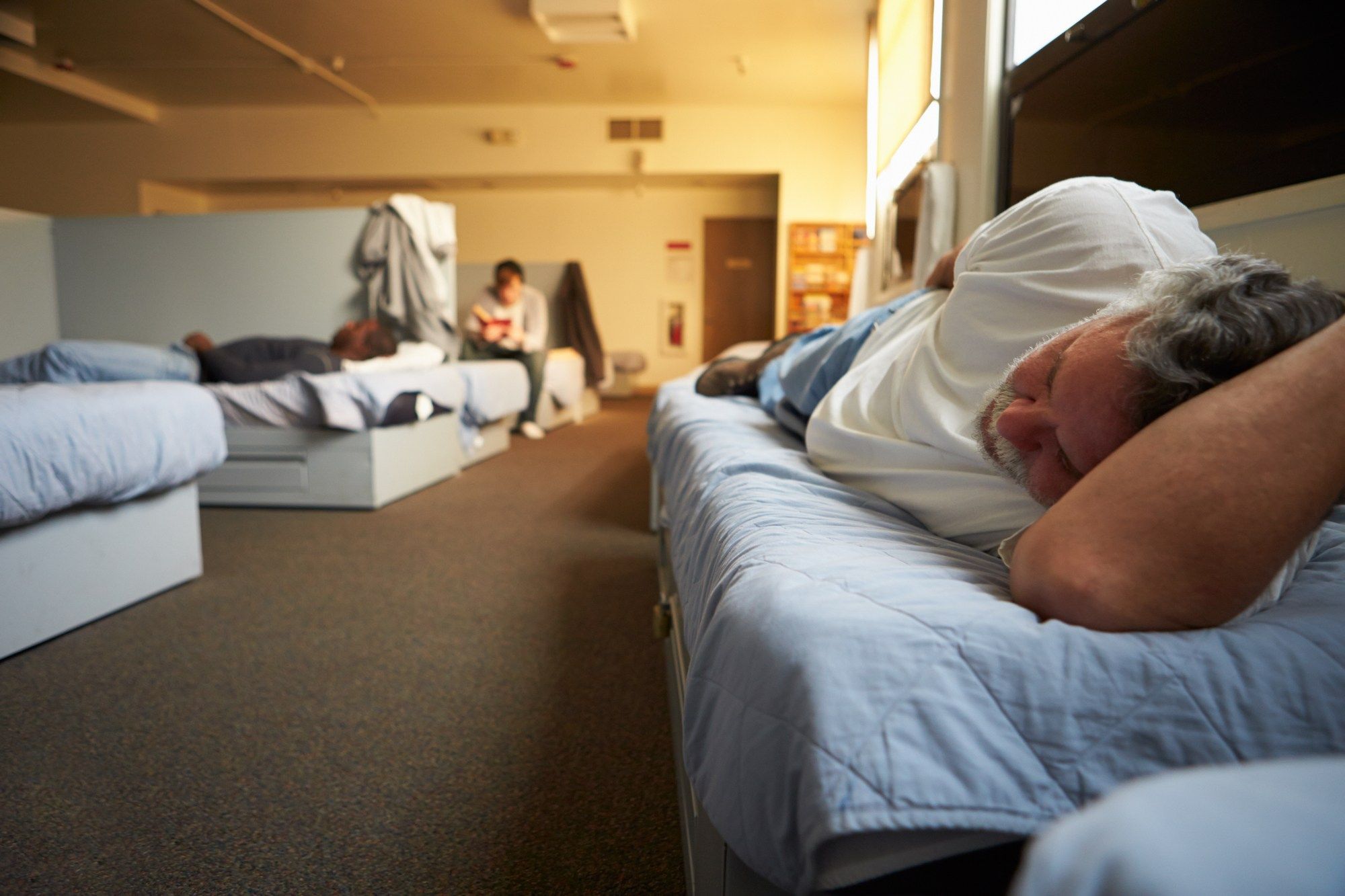 Men sleeping in a shelter regarding the homeless shelter lawsuit filed against Toronto over its response to COVID-19 