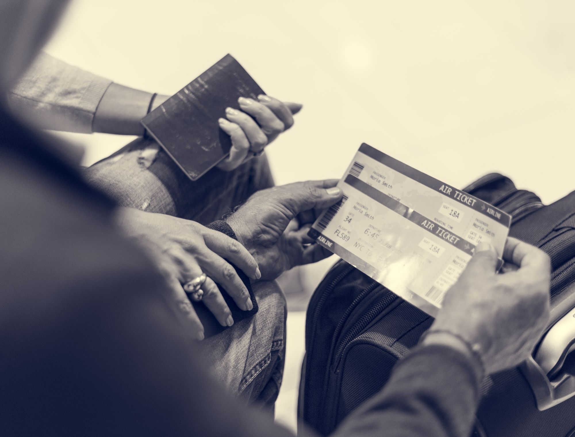 Pair of hands holding flight tickets regarding the class action filed against Air Canada over retirement benefits
