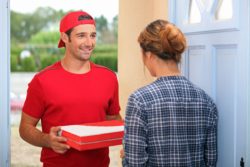 Man delivering pizza regarding the class action lawsuit filed against Pizza Nova