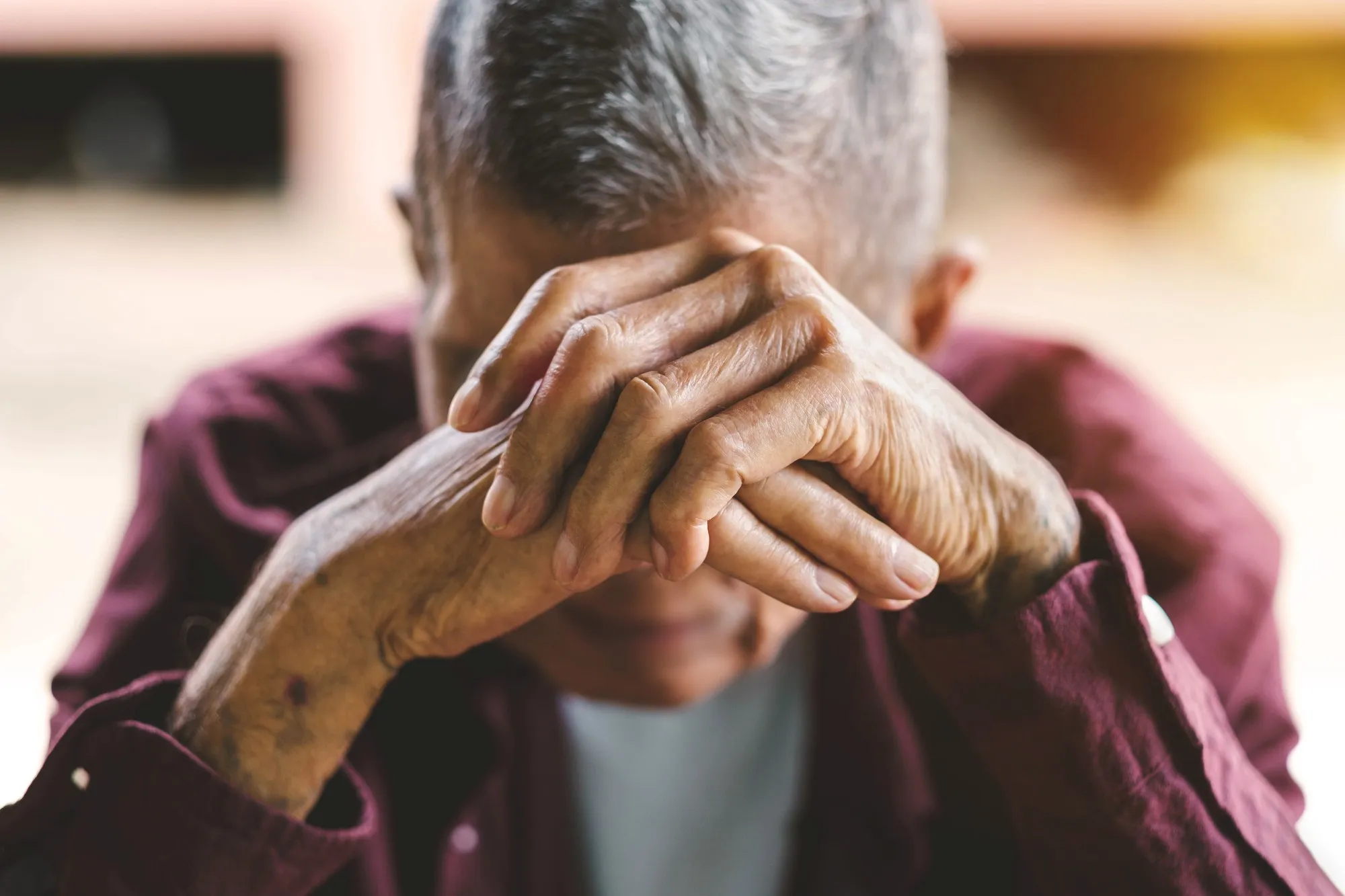 Senior man with hand over face regarding the care homes class action lawsuit filed against Responsive Group over its response to COVID-19