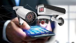 Smartphone with security cameras around it regarding the privacy concerns raised by Canada's COVID-19 response