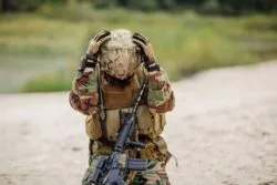 Soldier holding his helmet regarding lawsuit s to be filed against mefloquine over severe side effects suffered by military service members