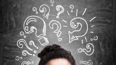 Woman with question marks above her head regarding information on what a class action settlement is