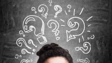Woman with question marks above her head regarding information on what a class action settlement is