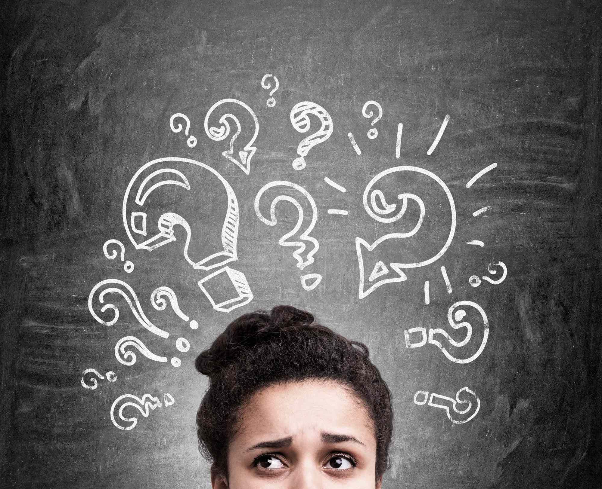 Woman with question marks above her head regarding information on what a class action settlement is