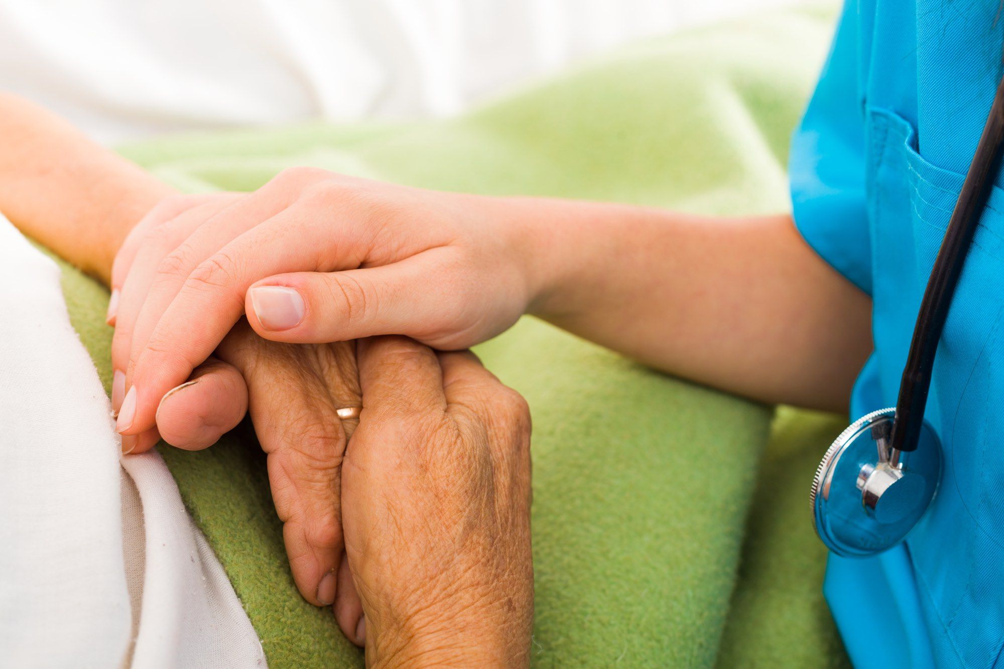 Health care worker treating elderly amid COVID-19