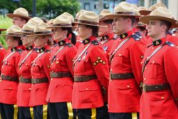 RCMP standing in a row regarding the RCMP class action lawsuit settlement opening for claims