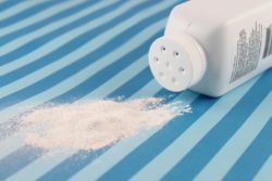 Spilled baby powder regarding Johnson and Johnson discontinuing its talc-based baby powder in Canada
