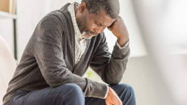 Man looking down upset regarding the nursing homes failed COVID-19 response class action lawsuit expanding to include Sienna Senior Living Inc.