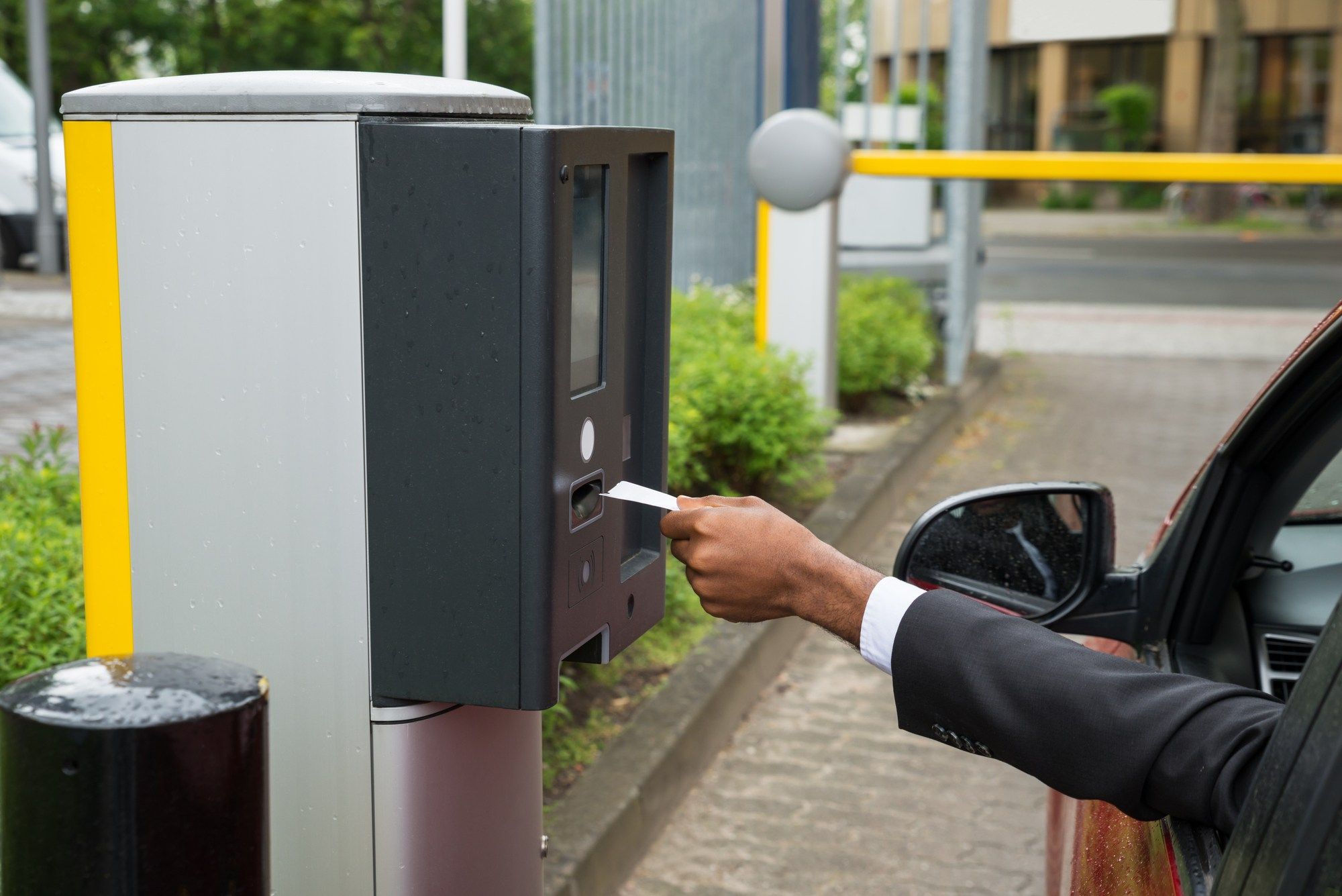 Arm using parking ticket machine regarding the University of Victoria parking permit class action lawsuit filed 