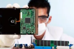 man holding hard disc drive regarding the class action lawsuit filed against Western Digital