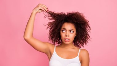 Woman looking concerned about her hair regarding the Deva Concepts hair loss class action lawsuit filed