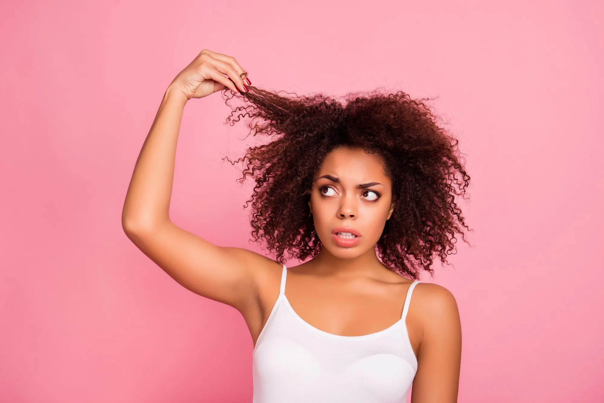Woman looking concerned about her hair regarding the Deva Concepts hair loss class action lawsuit filed