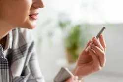woman holding joint regarding the tainted Organigram class action lawsuit claiming the pesticides in the cannabis makes users sick when burned and inhaled