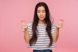 Woman making money sign with hands regarding the Stubhub ticket refund class action lawsuit filed 