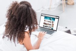 Woman browsing amazon on laptop regarding the Amazon price fixing class action lawsuit filed
