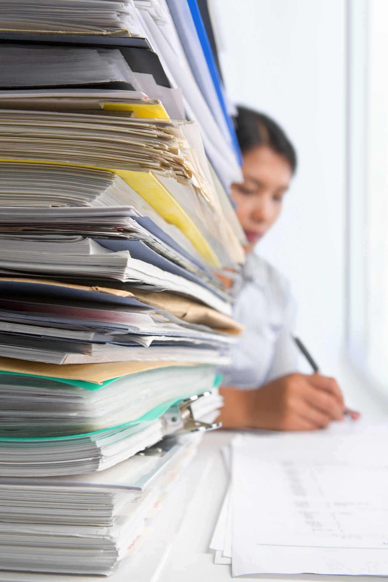 lawyer working on stack of paperwork regarding Alberta lawyers saying there will be a plethora of post-pandemic COVID-19 lawsuits