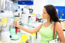 Shopper inspecting blender before purchase
