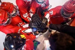 Aerial shot of a junior hockey team huddled regarding the CHL abuse and hazing class action lawsuit filed