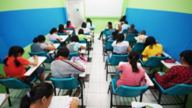 A blurred view from the back of a classroom regarding the teacher sexual abuse class action lawsuit allowed to move forward