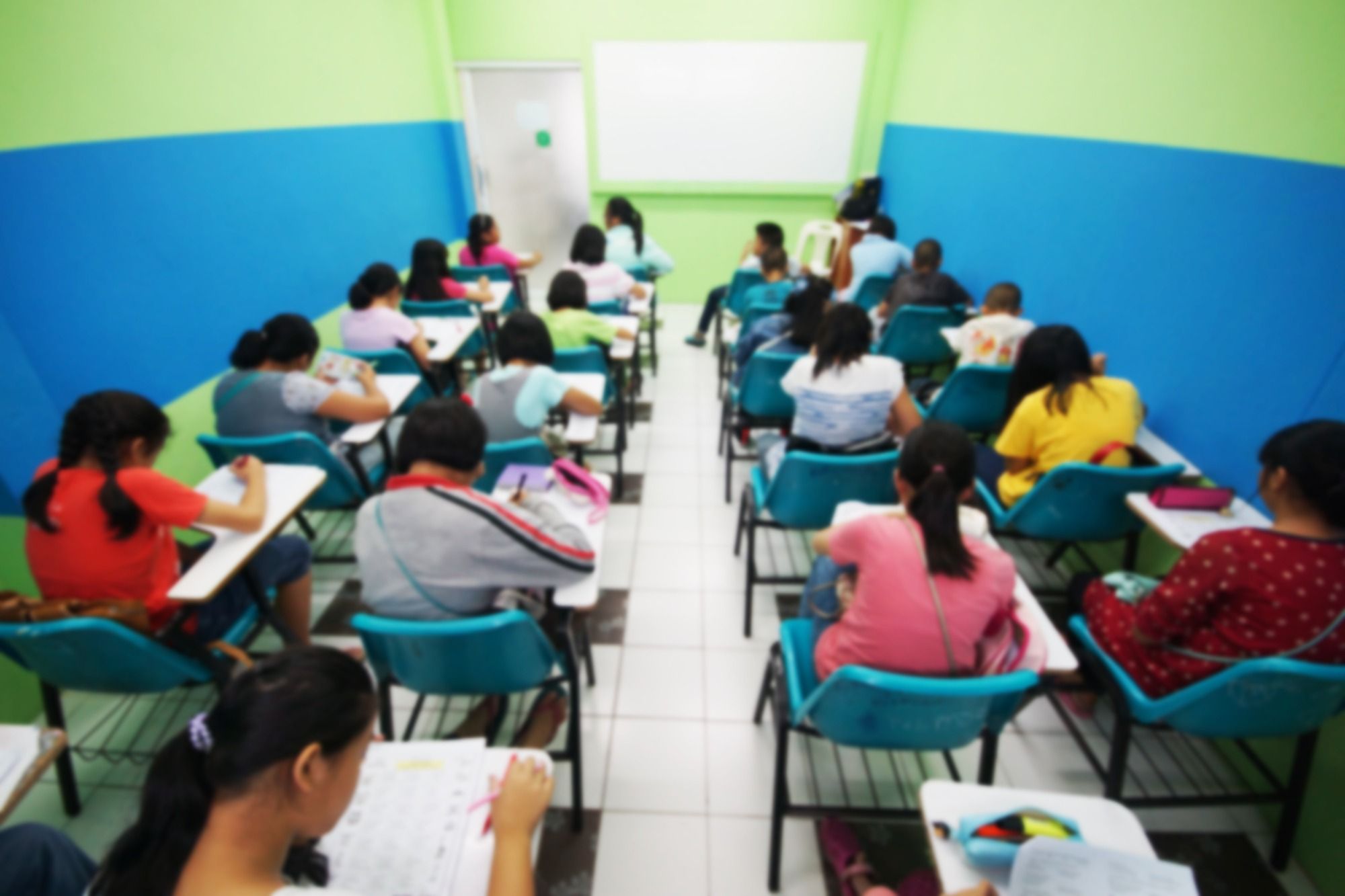 A blurred view from the back of a classroom regarding the teacher sexual abuse class action lawsuit allowed to move forward 