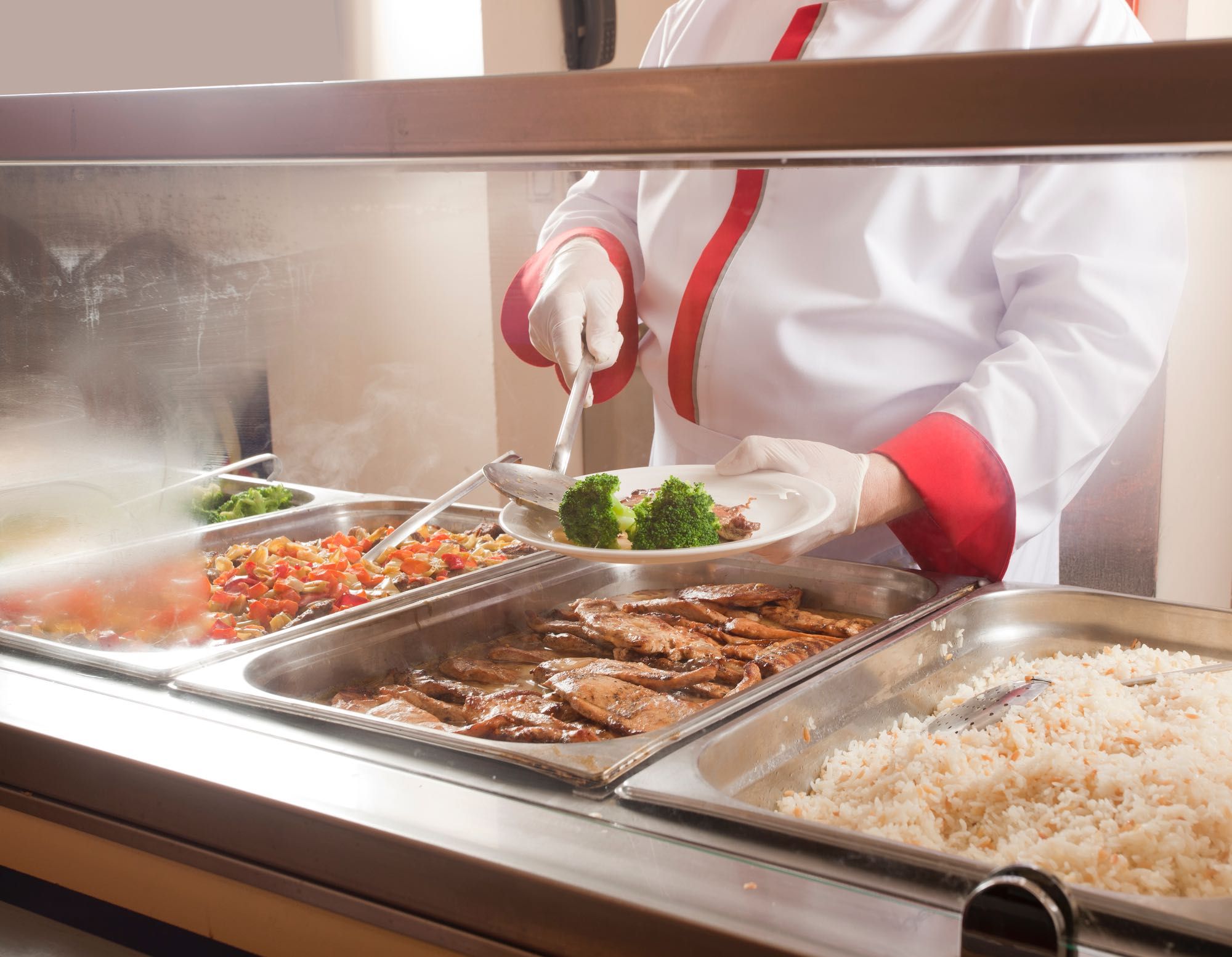 cafeteria cook serving food reduced during cover-19