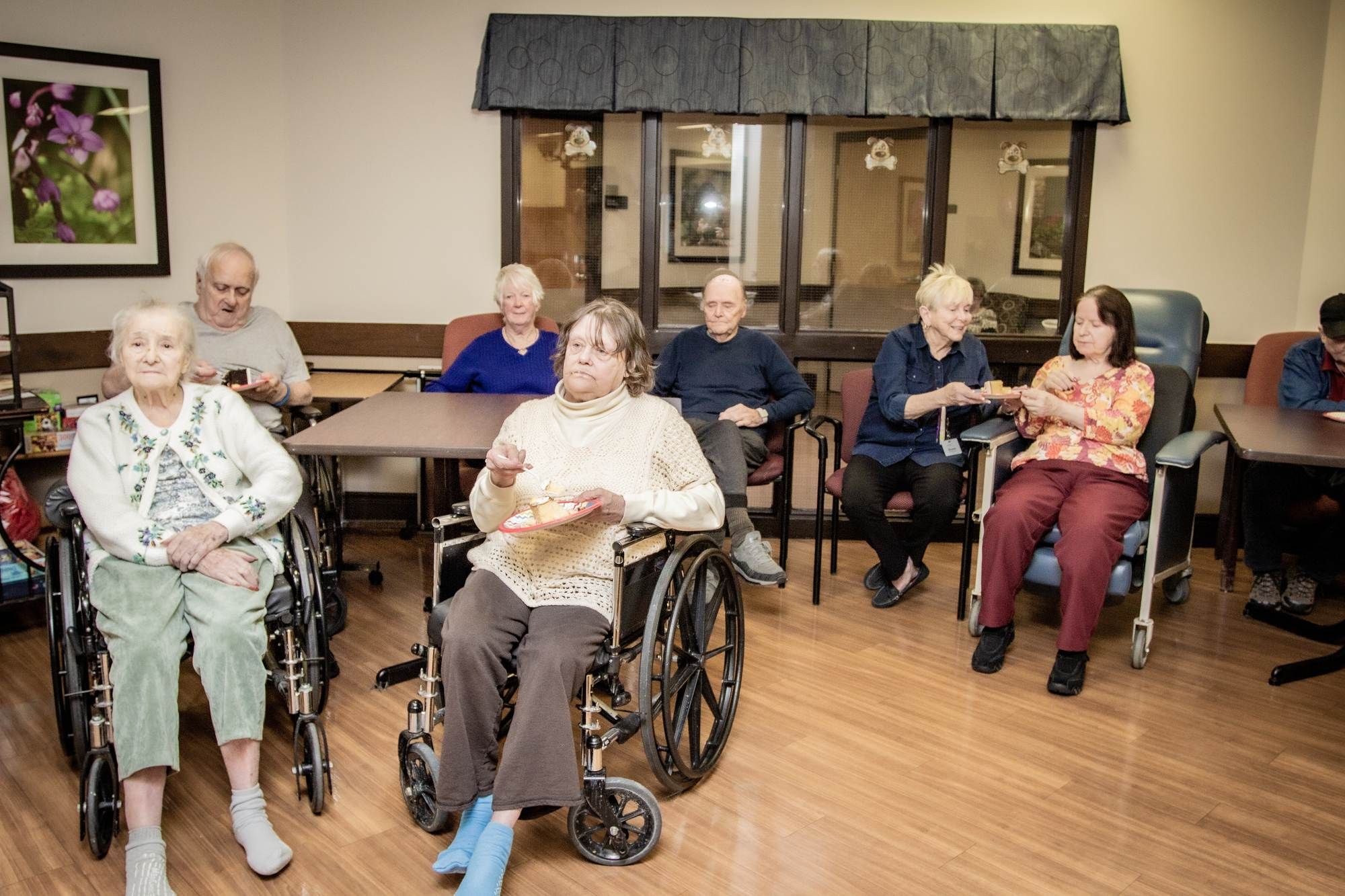 A group of senior citizens sitting regarding the Altamont Care Community class action lawsuit filed