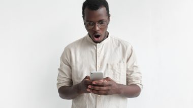 Man looking shocked and upset at phone regarding the Fitness Depot data breach