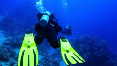 A scuba diver swimming regarding the Suunto defective dive computer class action lawsuit filed