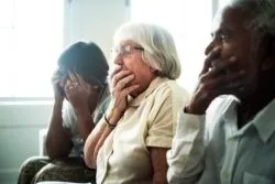 Seniors looking shocked and upset regarding the Woodbridge Vista Care Community class action lawsuit filed against the long term care homes' operators