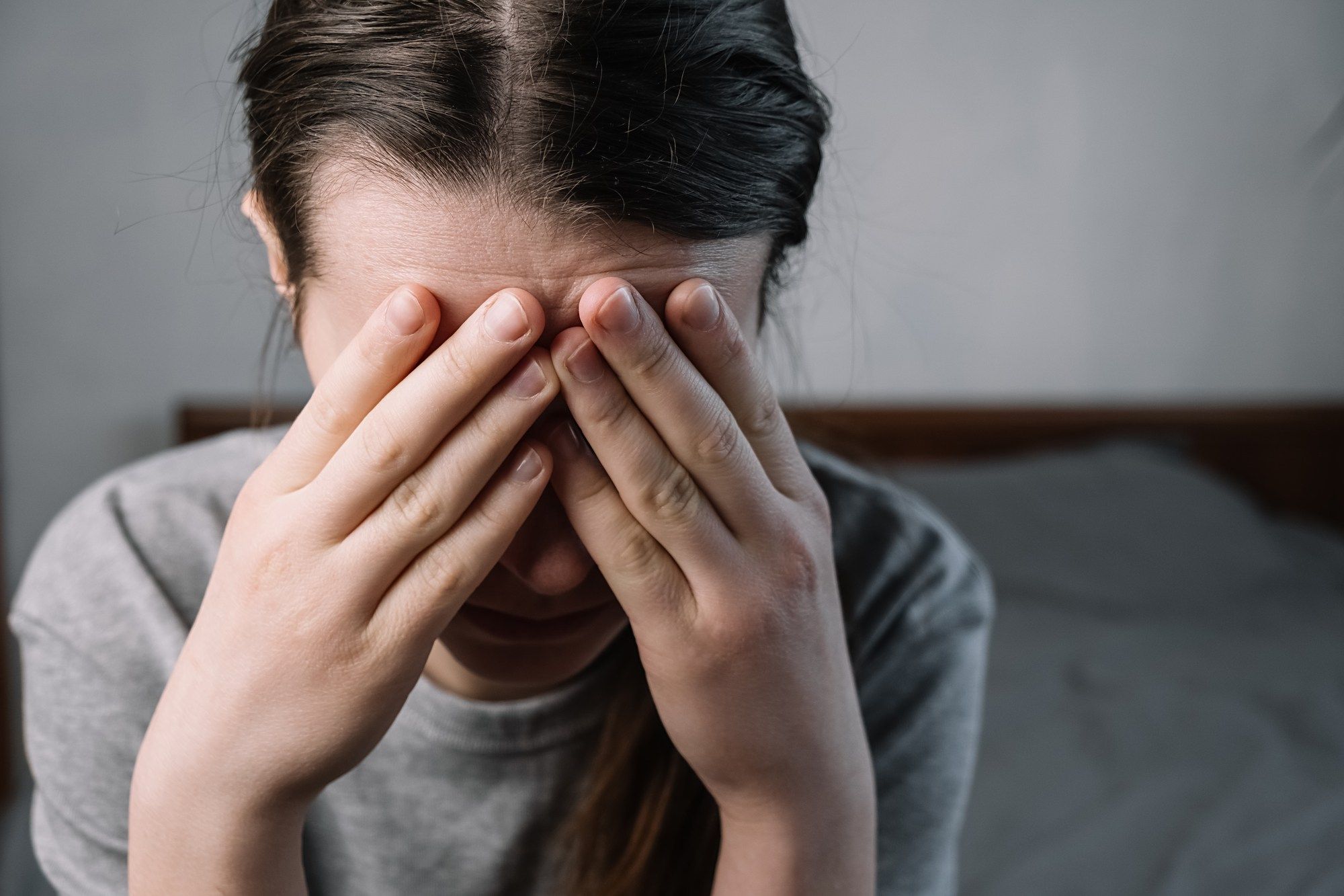 Upset woman with face in hands regarding the Methadose class action lawsuit 