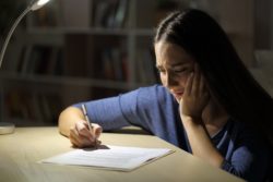 Woman upset filling out paper regarding the allegedly problematic Indian day school claim form 