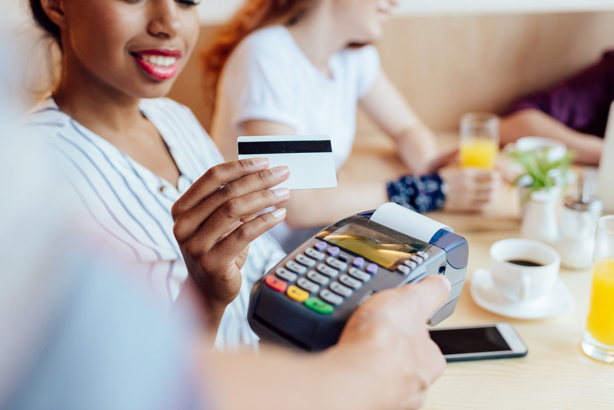 Woman using credit card regarding the Capitol One data breach class action lawsuit filed