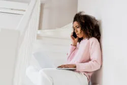 woman upset on the laptop and phone regarding the resale ticket refund class action lawsuit filed against group of online ticket distributors