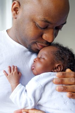 Baby of immigrant parents held by father