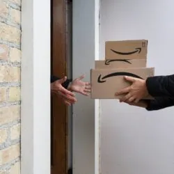 Amazon boxes being delivered regarding the Amazon delivery class action lawsuit filed 