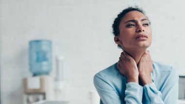 business woman suffering neck pain regarding information on Manulife Long Term Disability insurance