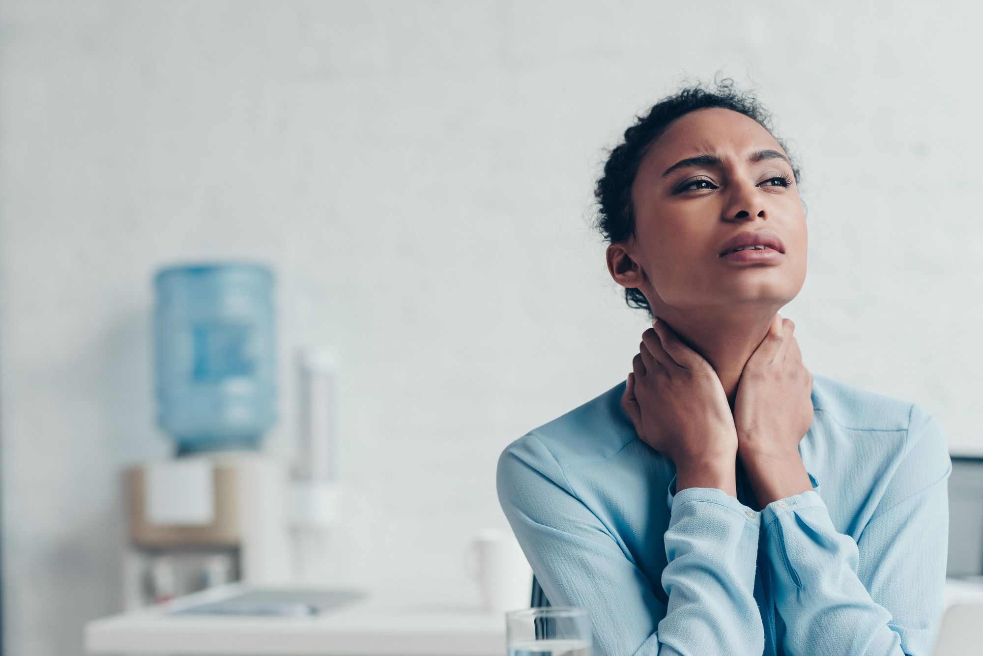 business woman suffering neck pain regarding information on Manulife Long Term Disability insurance