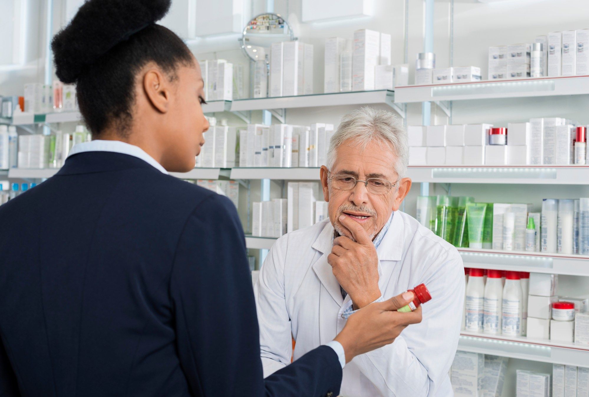 Woman speaking with pharmacist regarding the pharmacy privacy breach class action lawsuit filed