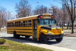 Yellow school bus empty as school trip cancelled due to covid-19