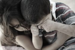 little girl holding sad little boy regarding the foster children class action settlement reached
