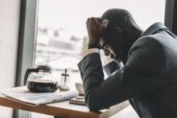 business man distressed after COVID-19 insurance claims denied due to force majeure