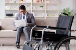 man on couch researching long term disability insurance