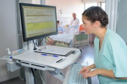 Nurse entering information regarding the LifeLabs cybersecurity privacy breach class action lawsuit filed