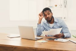 upset man holding papers regarding what to do if your LTD benefits are revoked